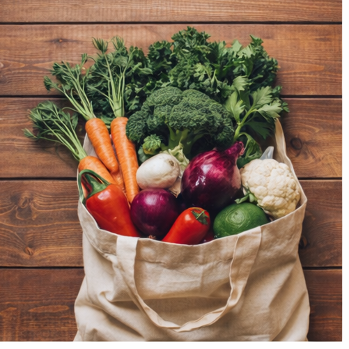 canvas bag filled with vegetables on wooden table